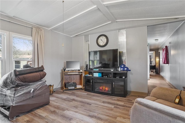 living room featuring vaulted ceiling with beams and hardwood / wood-style floors