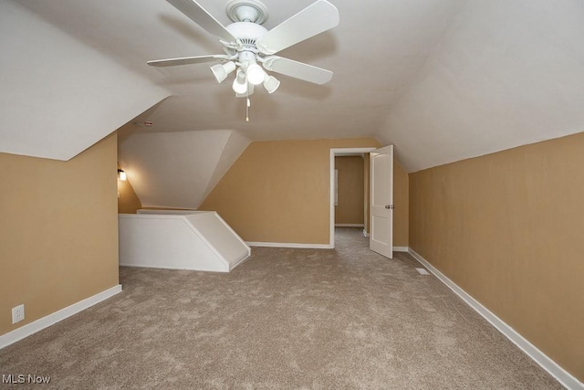 bonus room with ceiling fan, light carpet, and vaulted ceiling