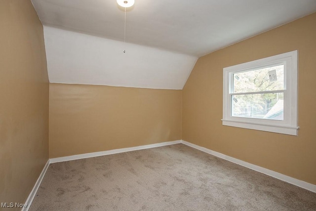 bonus room featuring lofted ceiling and carpet floors