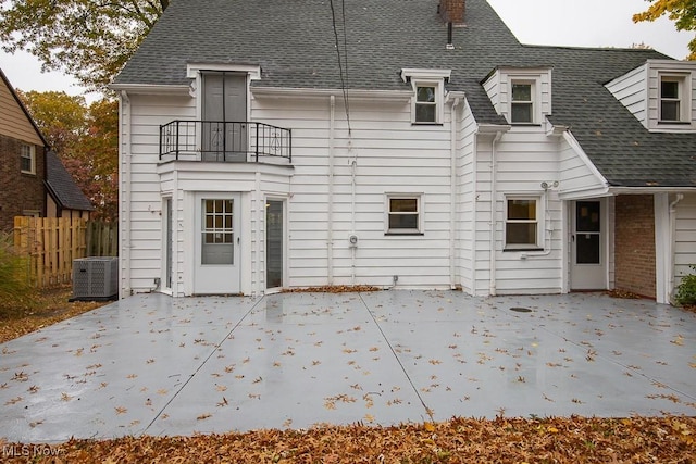 rear view of house featuring a patio, a balcony, and central AC unit