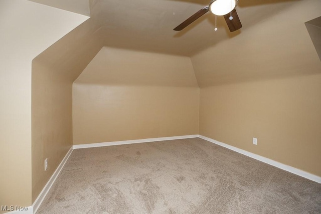 additional living space featuring ceiling fan, carpet, and lofted ceiling