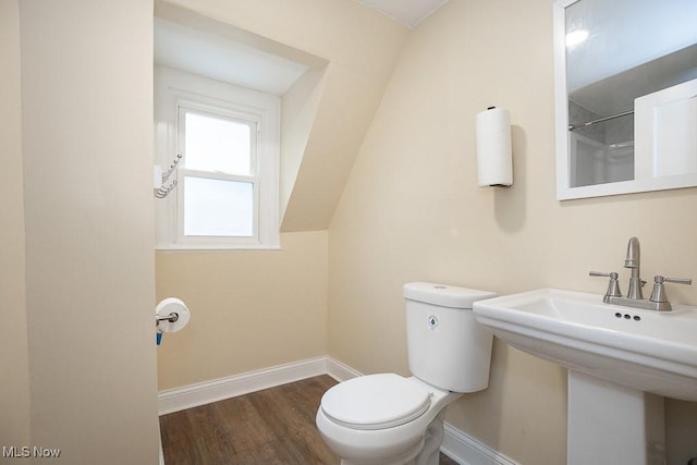 bathroom with hardwood / wood-style flooring and toilet