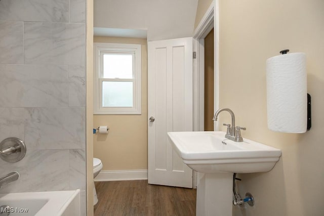 bathroom with hardwood / wood-style flooring and toilet