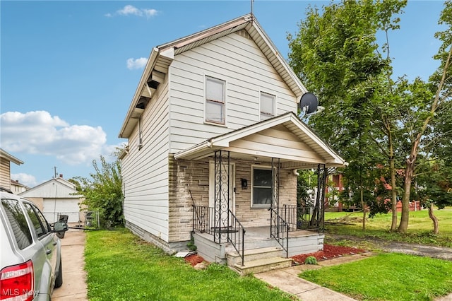 view of front facade with a porch and a front lawn