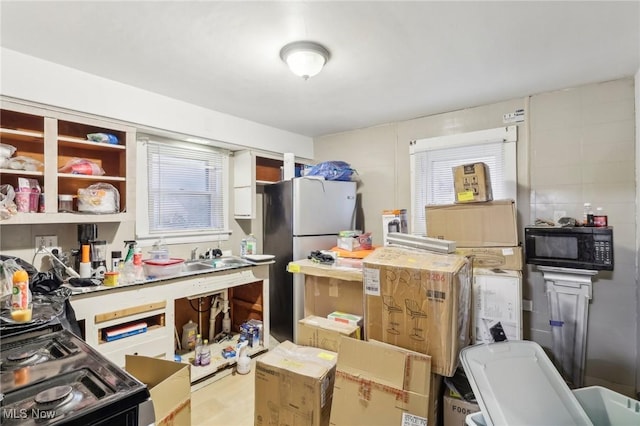 kitchen with stainless steel fridge and range