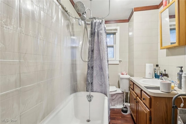 full bathroom with shower / bath combination with curtain, vanity, crown molding, tile walls, and toilet