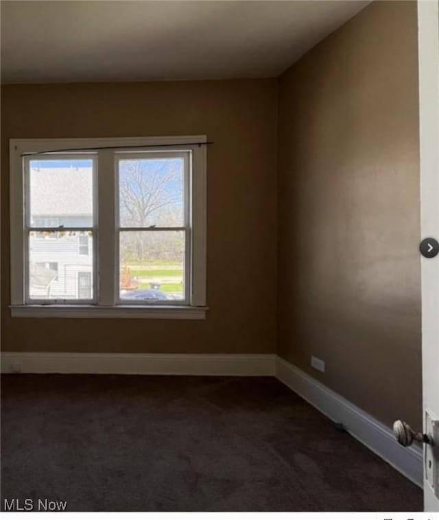 empty room featuring dark carpet