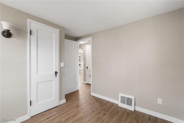 empty room featuring hardwood / wood-style flooring