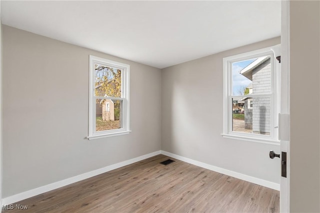 unfurnished room with light hardwood / wood-style flooring