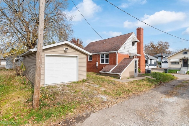 view of front of house featuring a garage and an outdoor structure