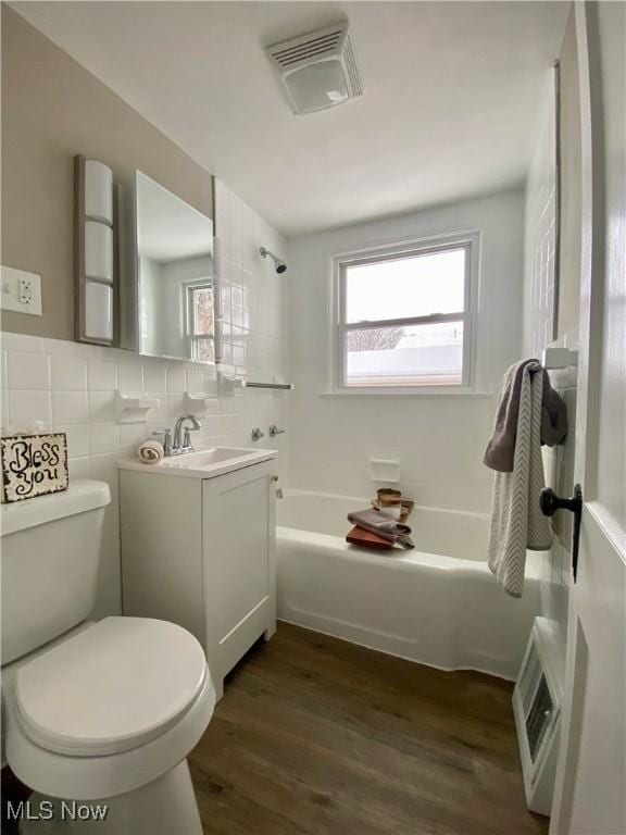 full bathroom featuring backsplash, vanity, shower / bathing tub combination, hardwood / wood-style floors, and toilet