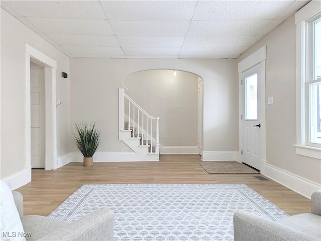 entryway with hardwood / wood-style flooring and a paneled ceiling