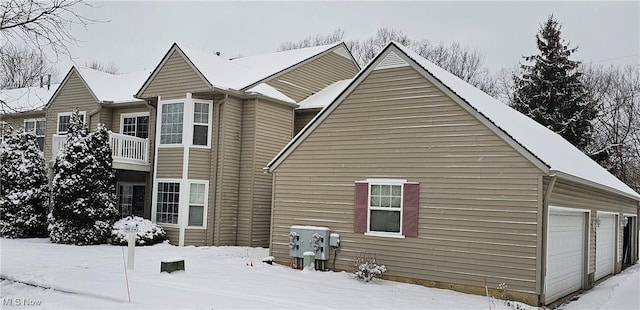 snow covered property with a balcony