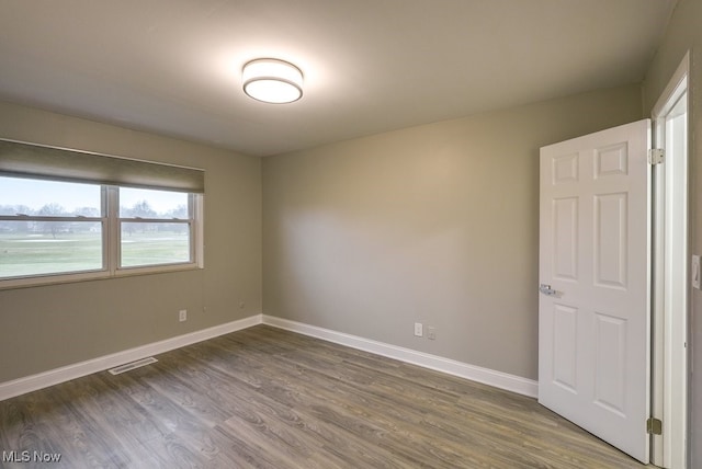 unfurnished room featuring hardwood / wood-style flooring