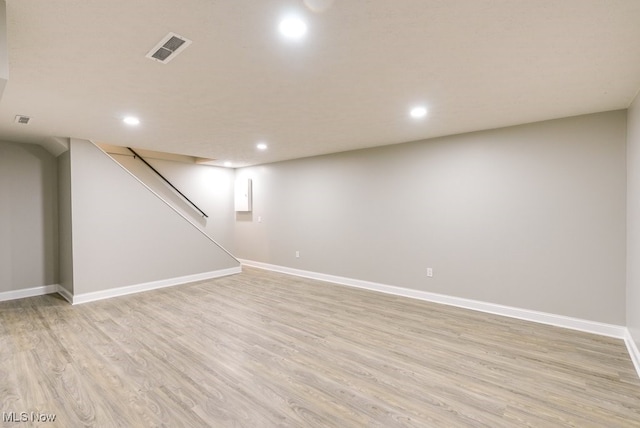 basement with light hardwood / wood-style floors