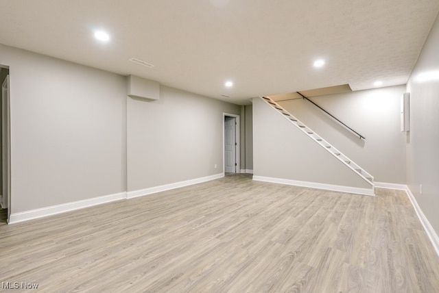 basement featuring light hardwood / wood-style flooring