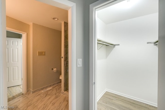 interior space featuring hardwood / wood-style flooring and toilet