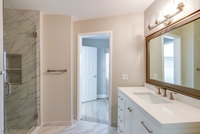 bathroom with vanity and a shower with shower door