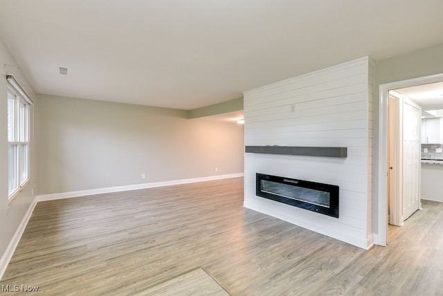 unfurnished living room with light wood-type flooring