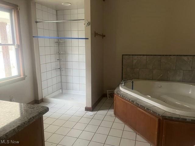 bathroom featuring a wealth of natural light, tile patterned flooring, vanity, and shower with separate bathtub