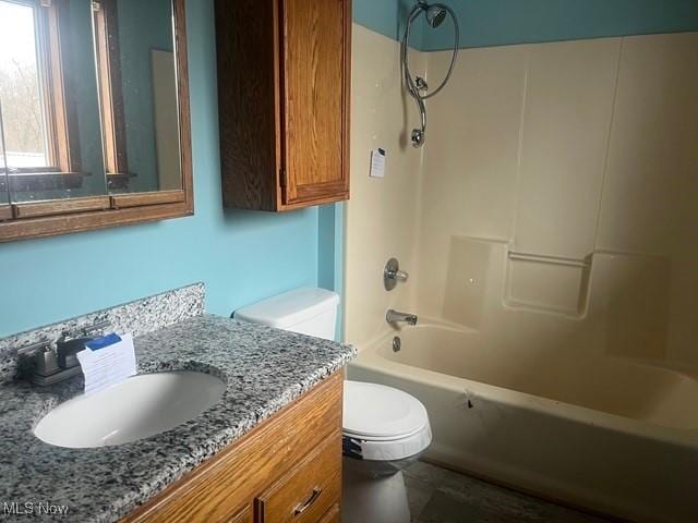 full bathroom with vanity,  shower combination, and toilet