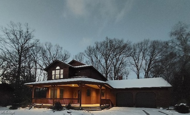 view of front of home featuring a porch and a garage