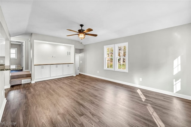 unfurnished living room with dark hardwood / wood-style flooring, ceiling fan, and lofted ceiling