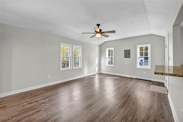 unfurnished living room with electric panel, ceiling fan, dark hardwood / wood-style flooring, and vaulted ceiling