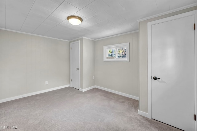 spare room featuring light carpet and ornamental molding