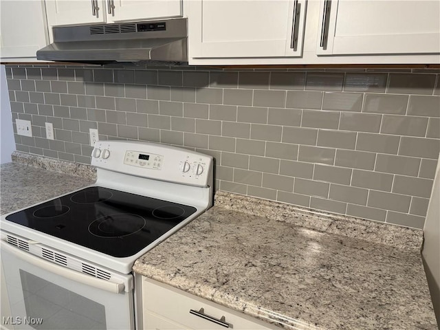 kitchen with decorative backsplash, electric range, white cabinetry, and light stone counters