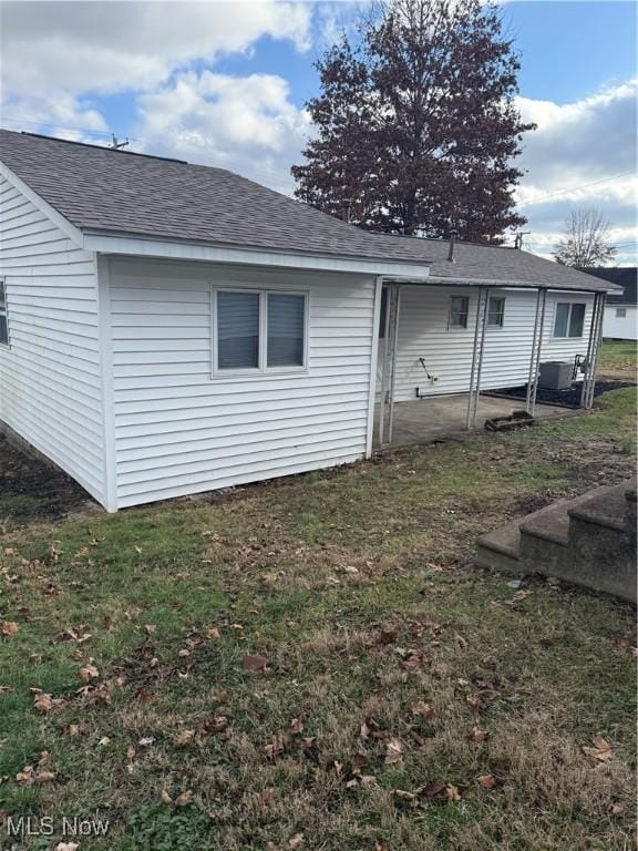 rear view of house featuring a yard