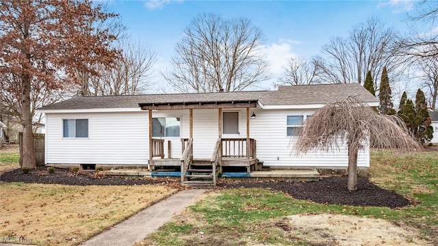 single story home featuring a shingled roof and a porch