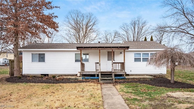 ranch-style house with a porch and a shingled roof