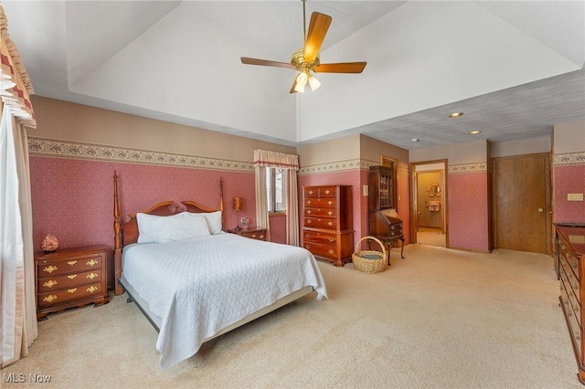 carpeted bedroom featuring ceiling fan and a high ceiling