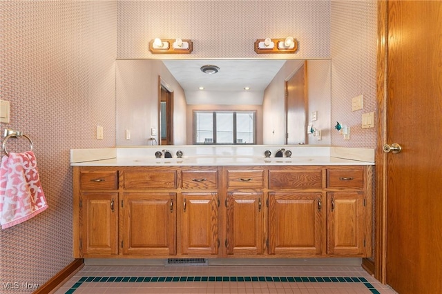 bathroom with tile patterned flooring and vanity