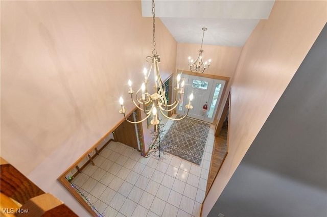 tiled entrance foyer featuring a chandelier