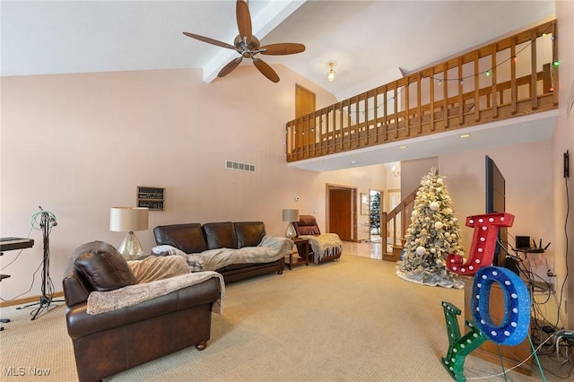 carpeted living room with high vaulted ceiling and ceiling fan