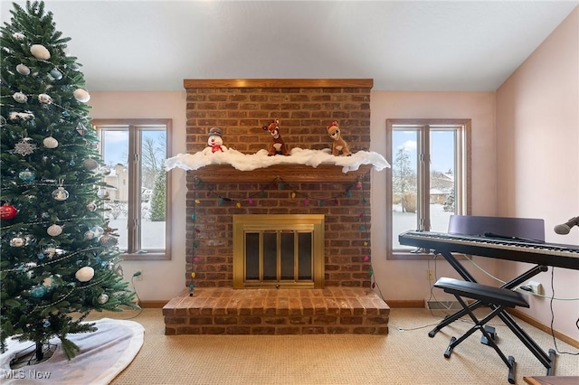 interior space featuring a fireplace, carpet flooring, and a wealth of natural light