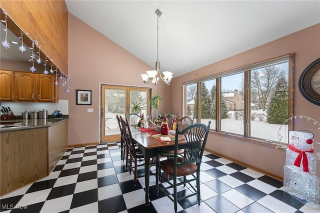 dining area with high vaulted ceiling and a chandelier