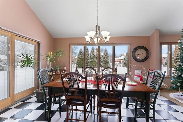 dining space featuring vaulted ceiling and an inviting chandelier