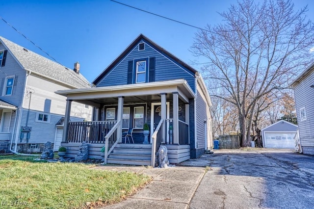 bungalow-style house with a porch, an outdoor structure, and a garage