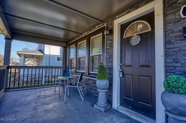 doorway to property featuring covered porch