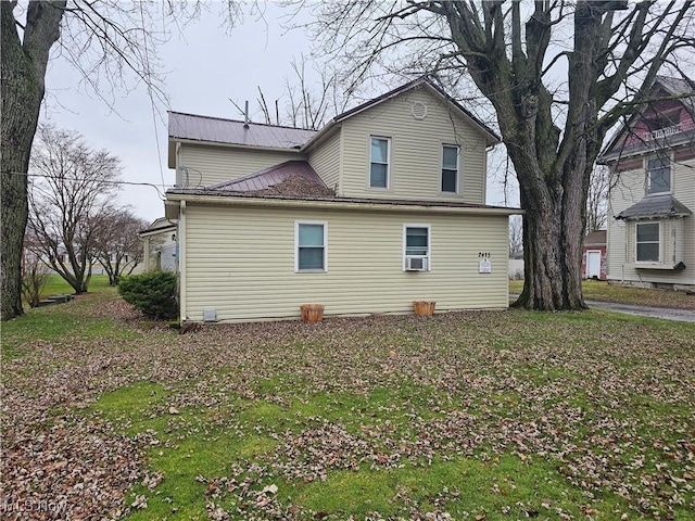 view of side of property with a lawn