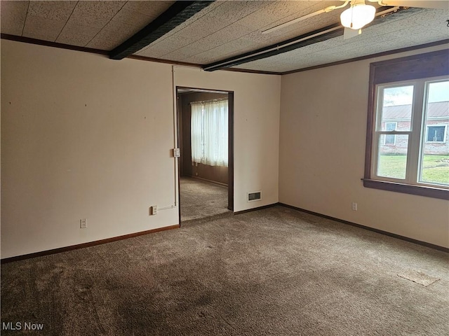 carpeted empty room featuring beamed ceiling, ceiling fan, and ornamental molding