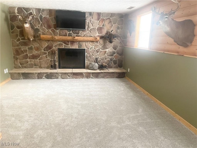 unfurnished living room featuring carpet flooring and a fireplace