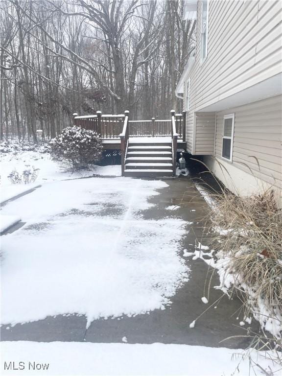 snowy yard featuring a deck