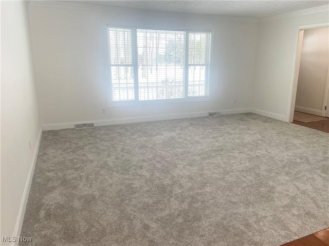 unfurnished room with carpet flooring and ornamental molding