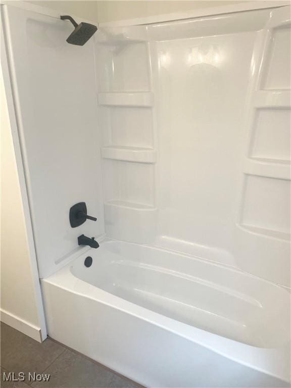 bathroom featuring tile patterned flooring and shower / bathtub combination