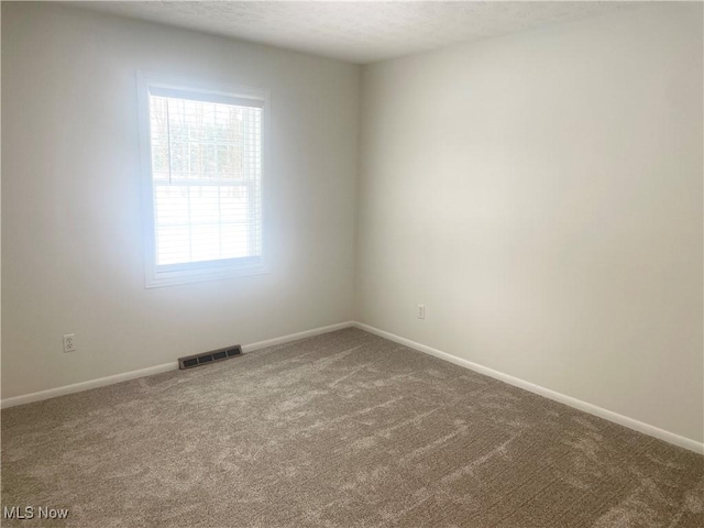 empty room featuring carpet flooring