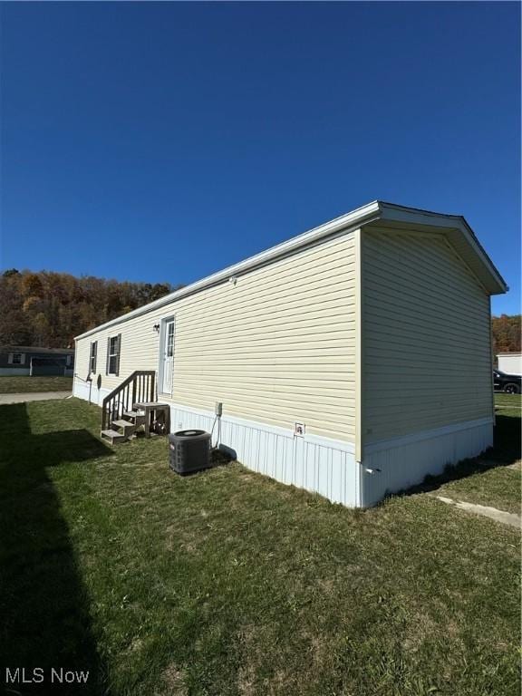 view of side of home with a lawn